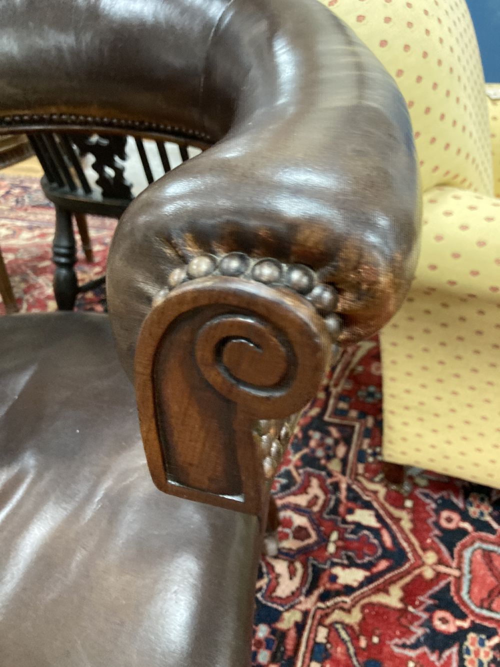 A Victorian mahogany and brown leather library chair